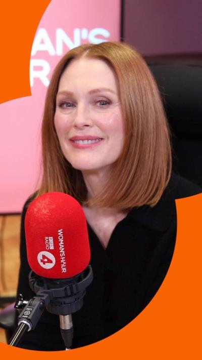 Actor Julianne Moore, smiling to camera, with Woman's Hour microphone in front