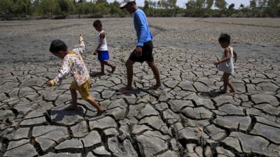 The cracked soil of a dried up fishery in the Philippines in South east Asia