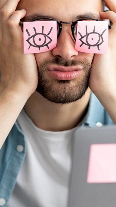 Man with post-it notes on his eyes