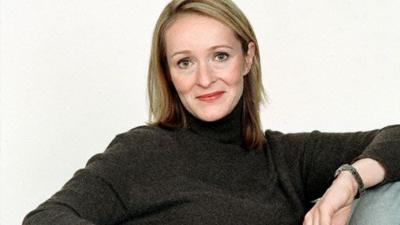 Tracey Macleod is shown wearing a black jumper in front of a white background.