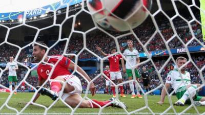 Gareth McAuley's touch sends the ball into his own net in the Euro 2016 defeat by Wales