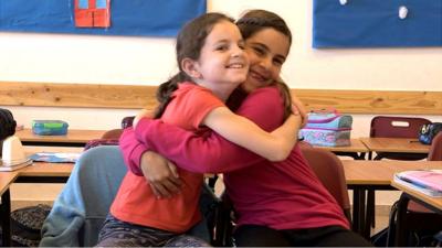 Jewish girl and Arab girl hugging