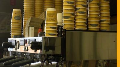 Coffee cups stacked on a coffee machine