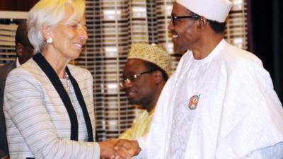 hristine Lagarde (L) shakes hands with Nigeria's President Muhammadu Buhar