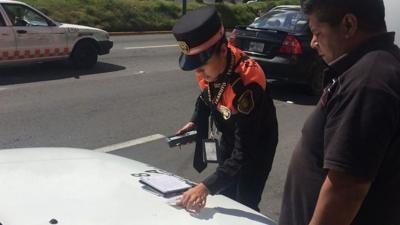 Policewoman checking driver's papers