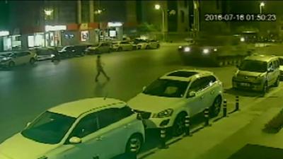 man in road as tank approaches