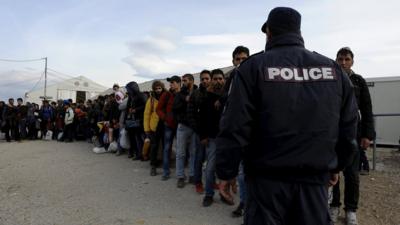 Refugees and migrants line up inside a camp, as they wait to cross Greece's border with Macedonia near the Greek village of Idomeni, November 10, 2015.