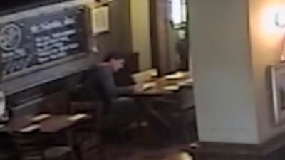 Still from footage shown to jury of Darren Osborne writing in a pub