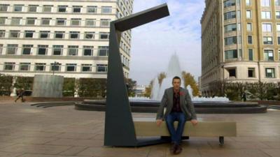 BBC Click's Spencer Kelly sits on a solar bench