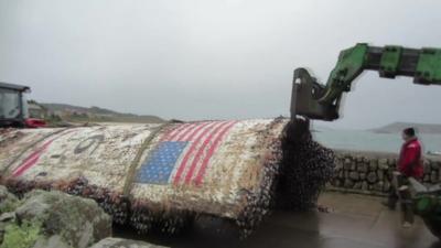 Rocket debris is removed from the beach on Tresco