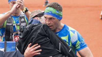 Kevin Sinfield carries Rob Burrow