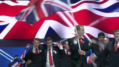 British team at the WorldSkills Competition waving British flags at opening ceremony
