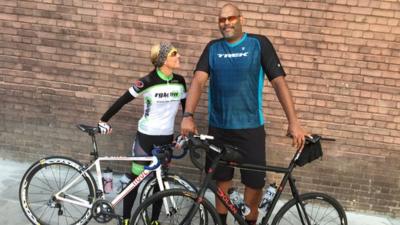 John Amaechi and trainer with their bikes