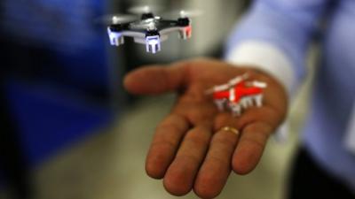 A man shows a mini drone.