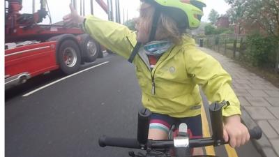 A family posts a video of a "kind" lorry driver overtaking cyclists, as their child shouts her thanks.