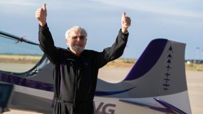 Jon Goodwin gives a thumbs up after completing G-force training before his flight