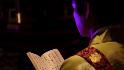 Man performs techno service in Shoonji temple in Japan.