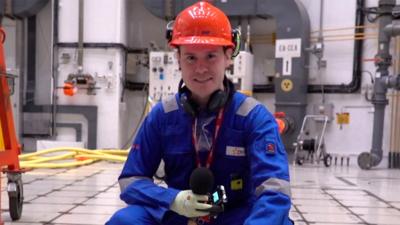 Jordan Dunbar standing on nuclear reactor