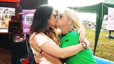 Two women kissing at the festival