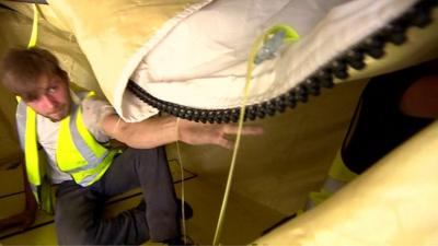 The 'bomb bag' is secured inside an aircraft hold for testing