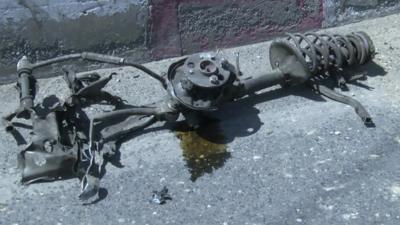 The remains of a vehicle destroyed by a suicide bomber