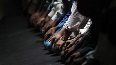 Muslim pray during the first day of Ramadan