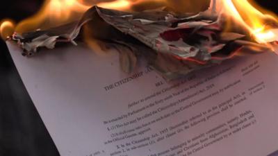 Protesters set fire to copies of the new citizenship bill