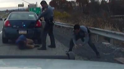 The fleeing suspect grabs a gun and opens fire as police officers dive for cover and shoot back.