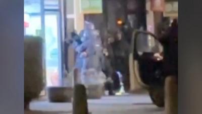 Armed police looking inside a takeaway