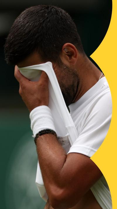 Sportsman wipes his face with his t-shirt