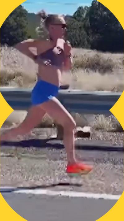 Calli Hauger-Thackery mid-stride during a run, wearing a purple crop top, blue shorts and orange trainers