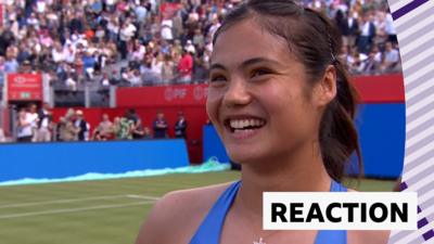 Emma Raducanu smiles on court 