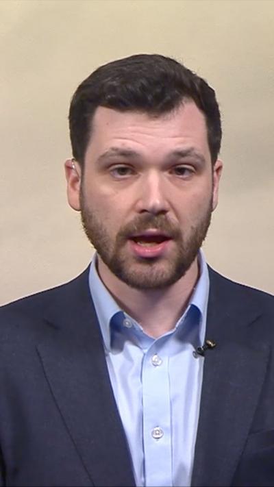Close-up of correspondent Henry Zeffman from newsroom studio