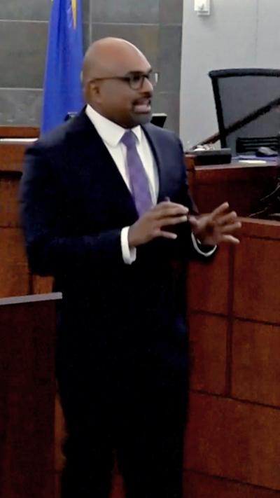Binu Palal wears a black suit in the courtroom.
