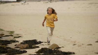 Boy running on beach