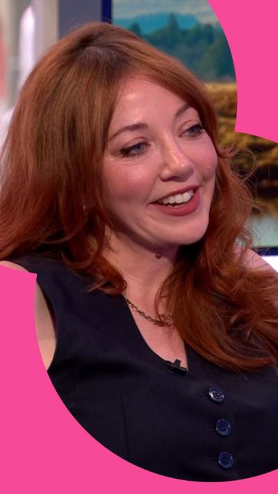 Diane Morgan sitting on the One Show sofa, smiling.