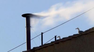white Smoke billowing from chimney