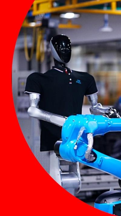 A robot in a polo shirt works on a factory line.