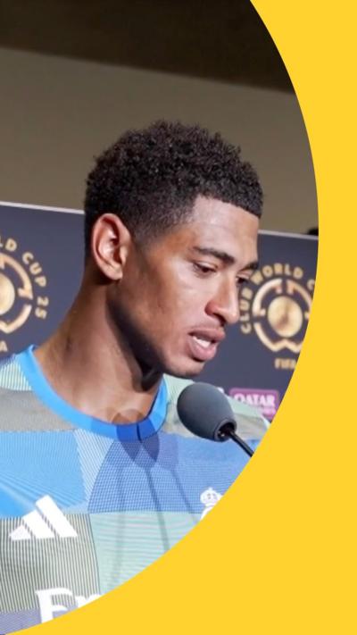 Footballer Jude Bellingham looking down,  in front of a microphone.