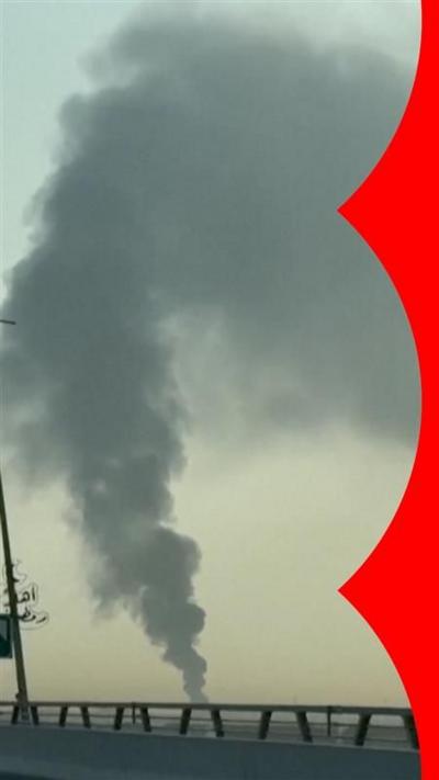 Smoke billows out in the distance 