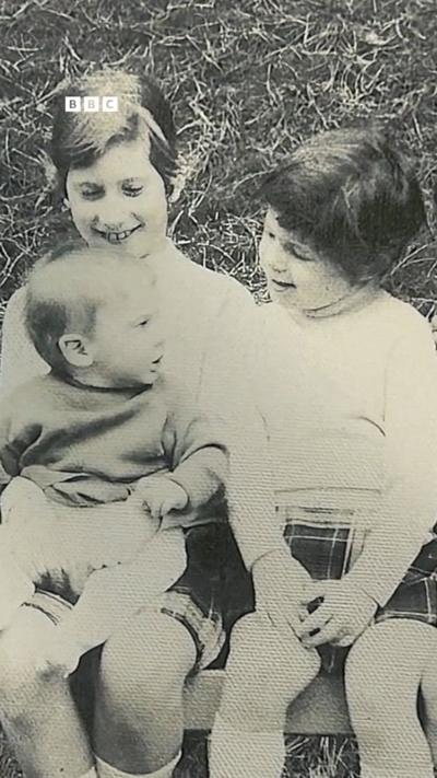 Three children in a black and white photo.