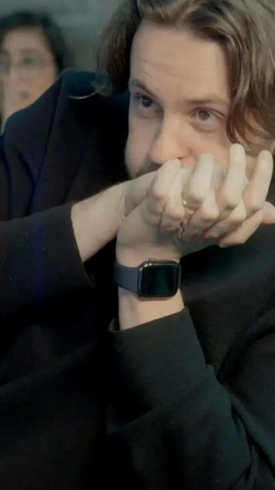 Man with long brown hair clasps hands against his face as he waits anxiously.
© BBC