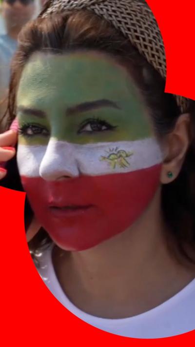 Woman with face painted in green, white and red
