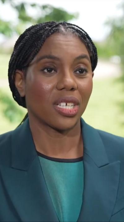 Kemi Badenoch wearing green