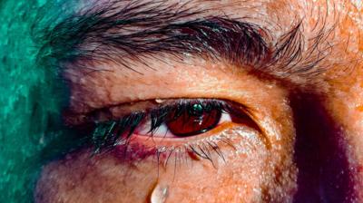 Close-up image of a man with a tear below his eye