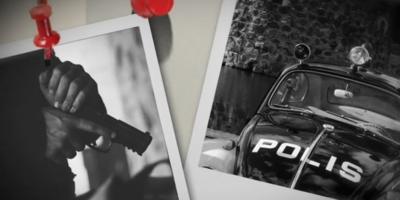 Two photograph with pins sticking them to the wall, one features a hand on a pistol and the other a 1970s Polis car