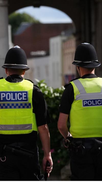 Police officers with their backs to the camera