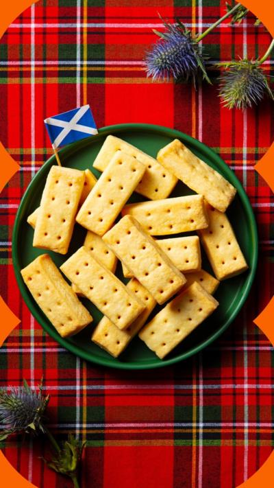 Shortbread biscuits on a green plate with a tartan tablecloth behind.