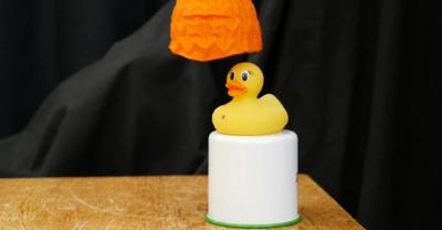 A robotic "Venus flytrap" hand picks up a yellow plastic duck