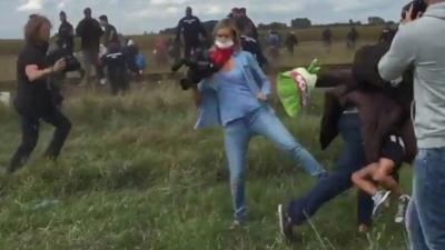 A Hungarian camerawoman appears to kick a migrant